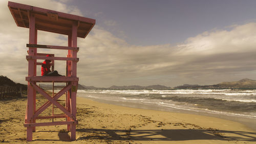 Lifeguard hut on beach against sky