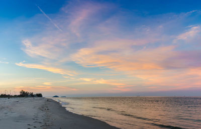 Scenic view of beach against sky during sunset