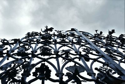 Low angle view of silhouette trees against sky