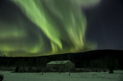 Scenic view of snow covered landscape against sky at night