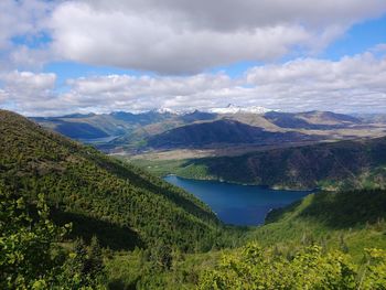 Scenic view of lake and mountains against sky