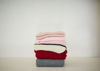 Close-up of hat on table against wall