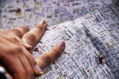 Cropped hands of woman holding map