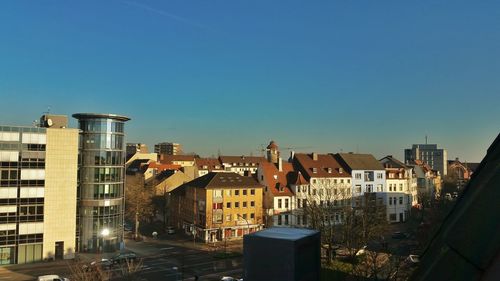 Buildings in city against blue sky