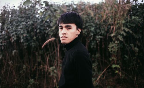 Portrait of young man in forest