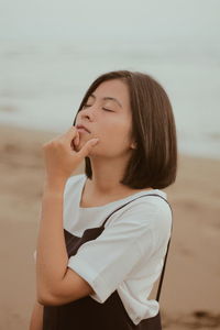 Beautiful woman standing on beach