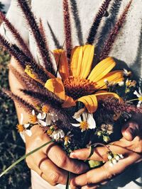 Midsection of woman holding flowering plant