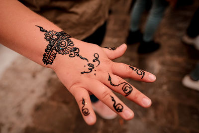 Close-up of girls hand with tattoo