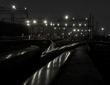 Illuminated street lights in city at night