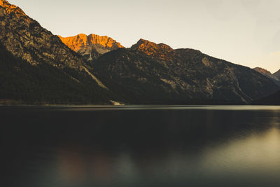 Scenic view of lake and mountains against sky