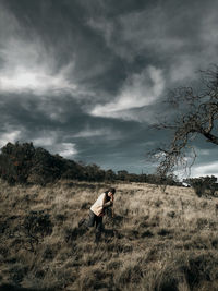 Man standing on field against sky