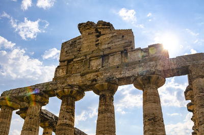 Ray of sun through the columns of the temple of athena 500 bc. archaeological site of paestum