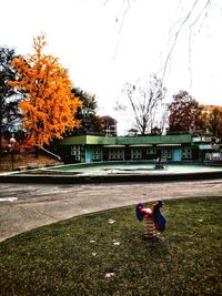 Man in park against sky during autumn