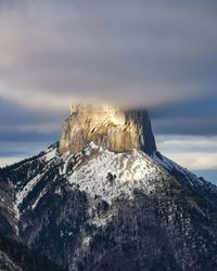 Low angle view of snowcapped mountain against sky