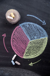 High angle view of colorful chalks on slate