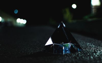 Pyramid shape crystal on road at night