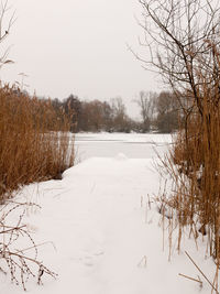 Snow covered field against clear sky