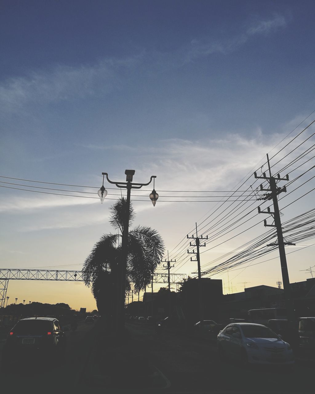 cable, car, sky, power line, transportation, electricity, electricity pylon, power supply, connection, silhouette, cloud - sky, land vehicle, tree, no people, fuel and power generation, outdoors, sunset, nature, telephone line, day, technology