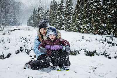 Outdoor winter activities for kids and family. let it snow. happy family mom and kid boy having fun