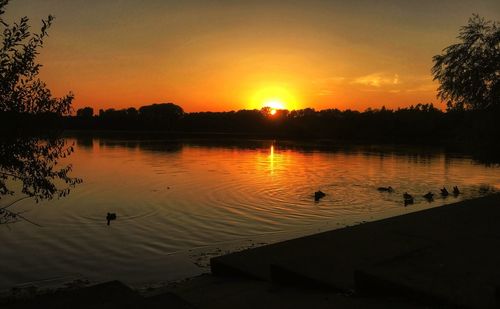Scenic view of lake against sky during sunset