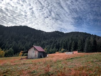 Old abandoned cabin in the mountains on a cloudy day