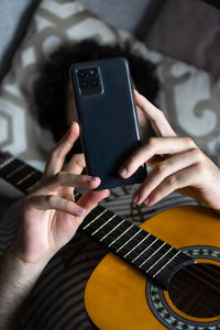 Midsection of man using mobile phone