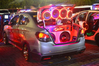 View of illuminated cars on street at night