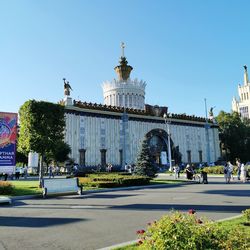 Buildings in city against blue sky