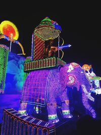 Low angle view of illuminated ferris wheel at night