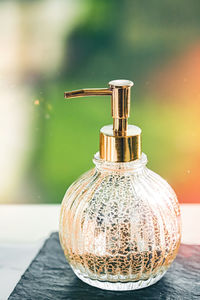 Close-up of glass bottle on table