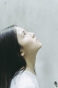 Side view of young woman looking up