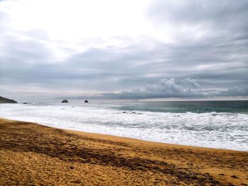 Scenic view of beach against sky