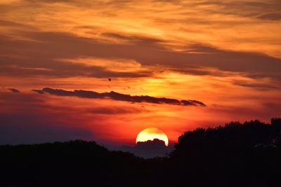 Scenic view of silhouette landscape against romantic sky at sunset