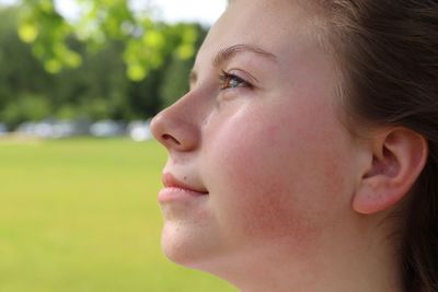 Profile view of thoughtful young woman at park