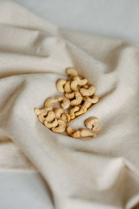 Photo of cashew nuts natural light linen natural textures beige lifestyle still life high level view