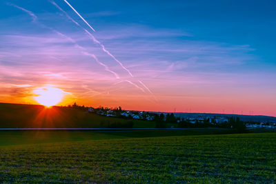 Scenic view of field against sky during sunset