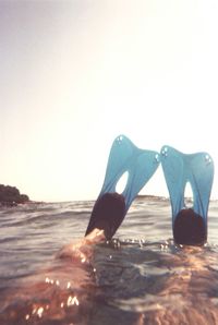 Close-up of sea shore against clear sky