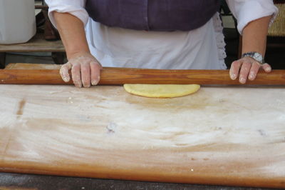 Midsection of person preparing food at table