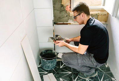 Side view of young man working