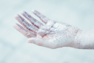 Close-up of hand against white background