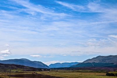 Scenic view of landscape against blue sky