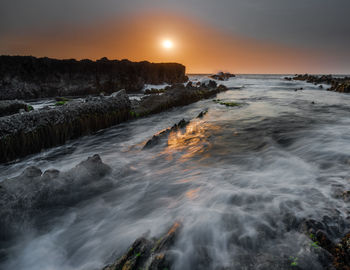 Scenic view of sea against sky during sunset