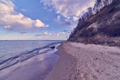 Scenic view of beach against sky during sunset