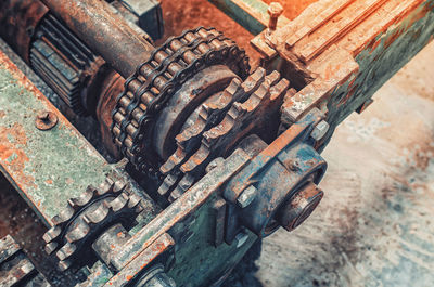 Corroded parts of old broken transmission close-up. rusty metal chain, transmission shafts.