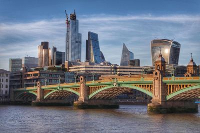 Bridge over river with buildings in background