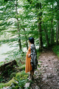 Rear view of man walking in forest