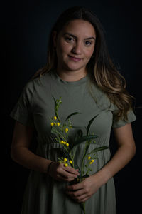Portrait of young woman with wild flowers
