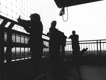 Silhouette people standing against sky