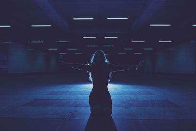 Young woman standing in underground walkway