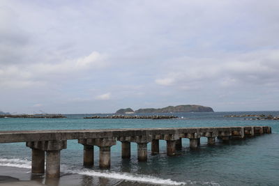 Pier over sea against sky